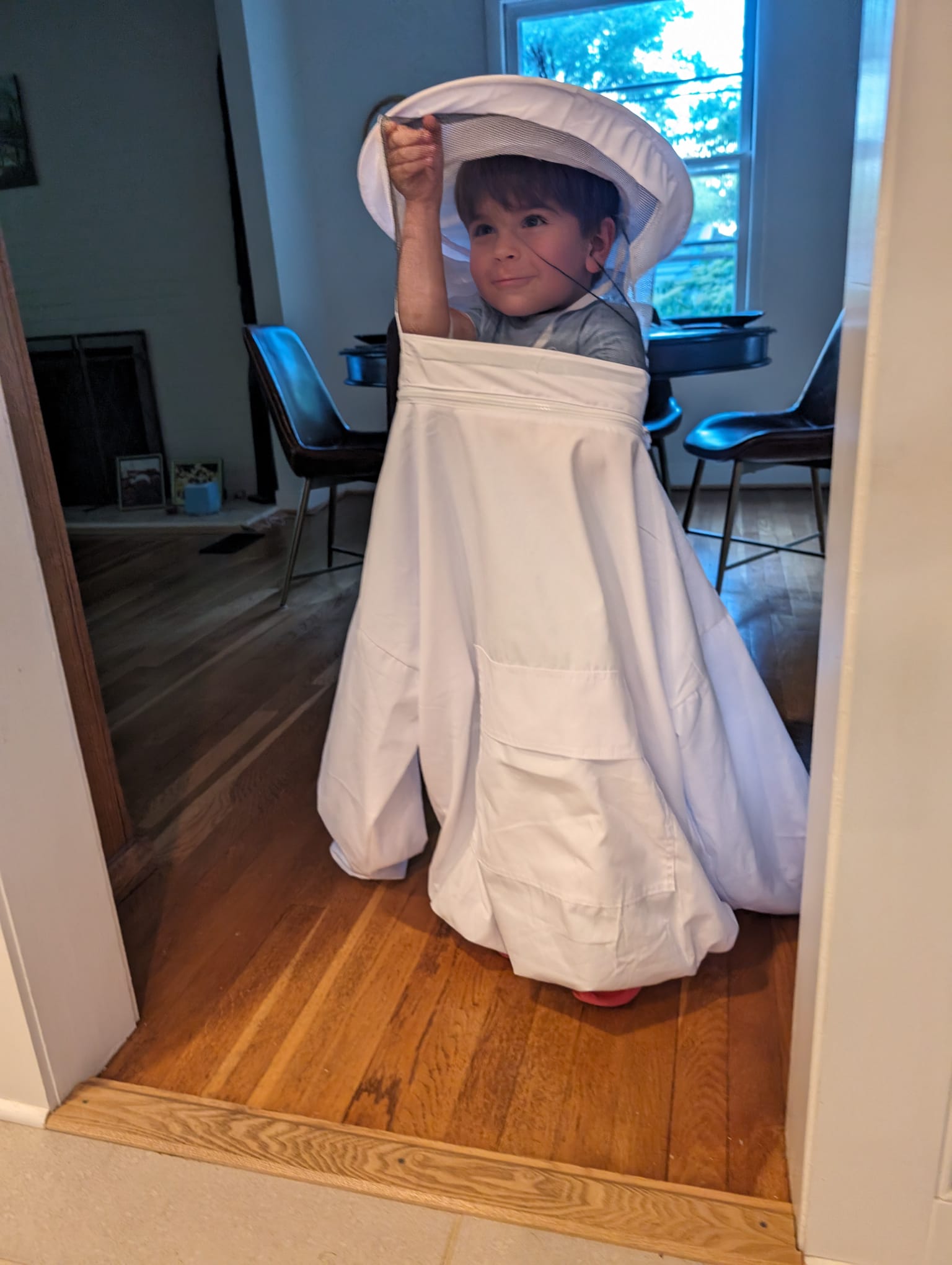 Lolo wearing his beekeeping suit and veil